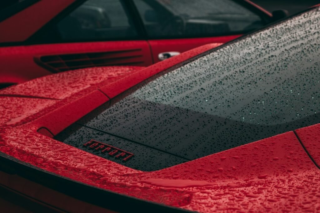 Red sports car outdoors illustrating paint care and protection in wet weather